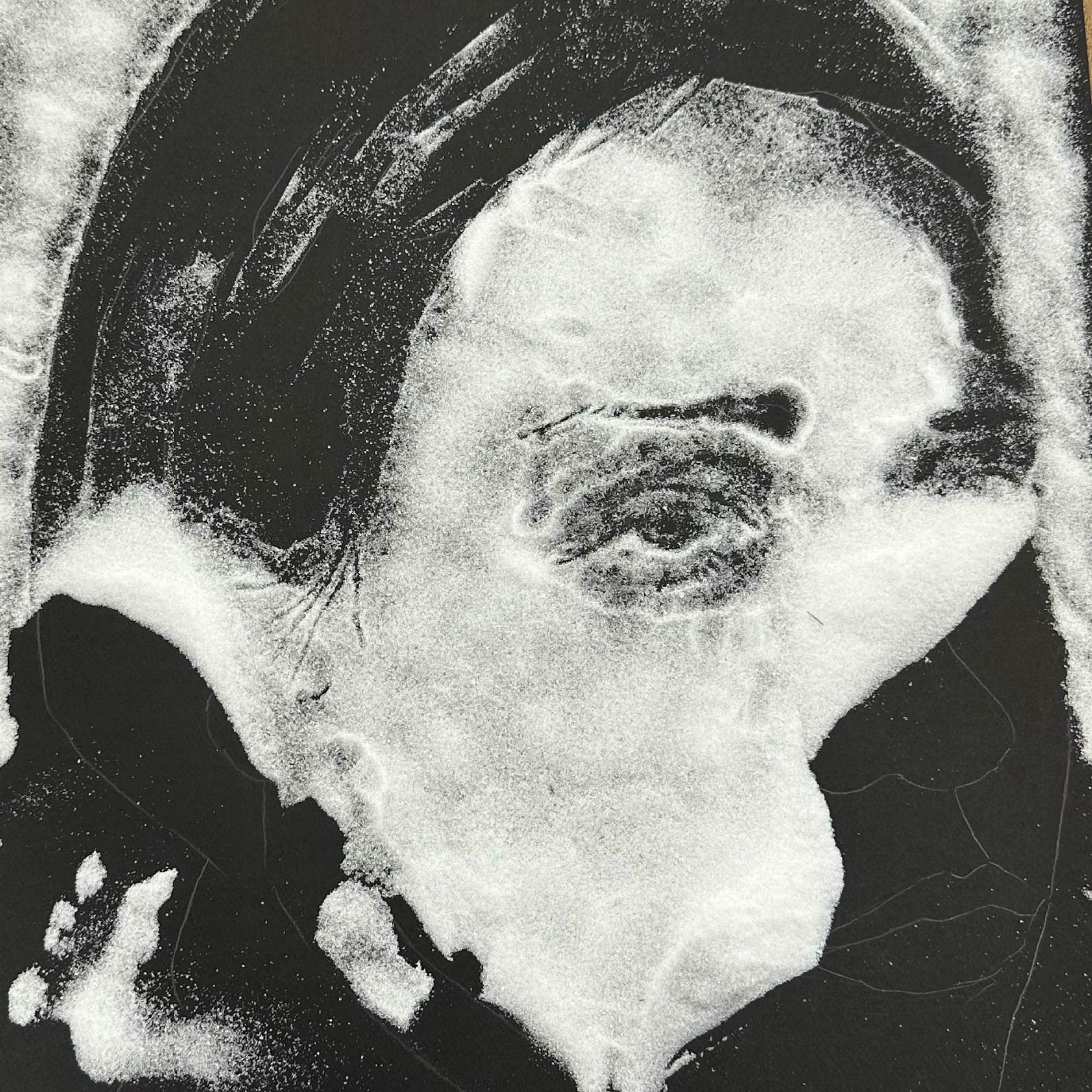 a woman's face made of salt disappearing